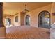 Covered outdoor patio with brick flooring and multiple archways at 14675 E Paradise Dr, Fountain Hills, AZ 85268