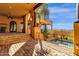 Outdoor patio featuring a built-in kitchen, water feature, and columns with outdoor ceiling fans at 14675 E Paradise Dr, Fountain Hills, AZ 85268