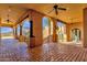 Spacious covered patio showcasing elegant columns, brick flooring, and panoramic mountain views at 14675 E Paradise Dr, Fountain Hills, AZ 85268