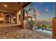 Spacious brick patio with wrought iron railing and a distant view of the refreshing pool and backyard at 14675 E Paradise Dr, Fountain Hills, AZ 85268
