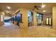 Expansive patio with brick flooring, pillars, arched openings offering scenic views, and access to outdoor kitchen at 14675 E Paradise Dr, Fountain Hills, AZ 85268