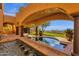 Backyard pool area featuring an archway, landscaping, and outdoor seating with scenic views at 14675 E Paradise Dr, Fountain Hills, AZ 85268