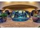 Exquisite backyard oasis featuring a waterfall feature, pool, and lush landscaping for ultimate relaxation at 14675 E Paradise Dr, Fountain Hills, AZ 85268