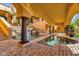 Resort-style pool area with rock waterfall, lush landscaping, and shaded seating at 14675 E Paradise Dr, Fountain Hills, AZ 85268