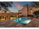 Backyard pool with beautiful architectural details, landscaping, and mountain views at dusk at 14675 E Paradise Dr, Fountain Hills, AZ 85268
