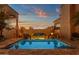 A luxurious pool at dusk offers a tranquil view, complemented by architectural details and a scenic backdrop at 14675 E Paradise Dr, Fountain Hills, AZ 85268