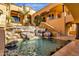 Stunning backyard pool with a rock waterfall, lush palms, and direct access to the home at 14675 E Paradise Dr, Fountain Hills, AZ 85268