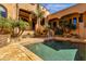 Luxurious pool with palm trees, covered walkways, and outdoor space for relaxing and entertaining at 14675 E Paradise Dr, Fountain Hills, AZ 85268