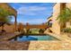 Private pool with connecting bridge between sections of a luxury home with lush desert landscaping at 14675 E Paradise Dr, Fountain Hills, AZ 85268