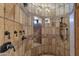 A tiled walk-in shower features multiple shower heads and built-in shelves at 14675 E Paradise Dr, Fountain Hills, AZ 85268