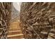 Unique spiral staircase featuring stone walls and tile steps, adding character to the home at 14675 E Paradise Dr, Fountain Hills, AZ 85268