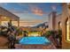 Desert property showcasing a luxury swimming pool, spa, lush landscaping and an inviting sunset view at 14675 E Paradise Dr, Fountain Hills, AZ 85268