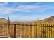 Scenic mountain and city views framed by a backyard fence and desert vegetation at 14675 E Paradise Dr, Fountain Hills, AZ 85268