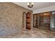 Impressive wine cellar with stone walls, wooden racks, and glass doors for display at 14675 E Paradise Dr, Fountain Hills, AZ 85268