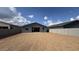 Vast dirt backyard enclosed by block fencing, offering privacy and potential for landscaping projects at 15769 W Beryl Ave, Waddell, AZ 85355
