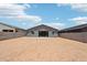 Wide shot of the backyard showing the expansive dirt yard and block fence at 15769 W Beryl Ave, Waddell, AZ 85355