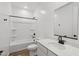Clean bathroom featuring a shower-tub combo, white vanity and toilet with modern black accents at 15769 W Beryl Ave, Waddell, AZ 85355