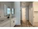 Bathroom with dual sinks, white cabinetry and tile floors at 15769 W Beryl Ave, Waddell, AZ 85355