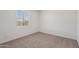 Cozy bedroom with neutral carpet, bright window, and a clean, minimalist design at 15769 W Beryl Ave, Waddell, AZ 85355
