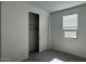 Bedroom with closet and window, neutral carpet, and freshly painted white walls at 15769 W Beryl Ave, Waddell, AZ 85355
