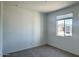 Cozy bedroom featuring neutral carpet, a large window providing natural light, and freshly painted walls at 15769 W Beryl Ave, Waddell, AZ 85355