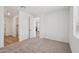 Well-lit bedroom with plush carpet and an open doorway leading to the next area of the home at 15769 W Beryl Ave, Waddell, AZ 85355