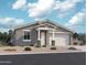 Charming single-story home with a two-car garage, desert landscaping, and a welcoming entryway at 15769 W Beryl Ave, Waddell, AZ 85355