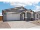 Charming single-story home with a two-car garage and neutral-toned exterior at 15769 W Beryl Ave, Waddell, AZ 85355