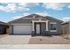 Charming single-story home with a two-car garage and neutral-toned exterior at 15769 W Beryl Ave, Waddell, AZ 85355
