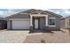 Charming single-story home with a two-car garage and neutral-toned exterior at 15769 W Beryl Ave, Waddell, AZ 85355
