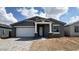 Charming single-story home featuring a two-car garage and inviting front porch with stone accents at 15769 W Beryl Ave, Waddell, AZ 85355