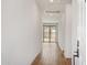 Bright hallway with wood flooring leading to the backyard at 15769 W Beryl Ave, Waddell, AZ 85355
