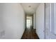 Bright hallway with wood-look flooring leading to an open living area with sliding glass doors at 15769 W Beryl Ave, Waddell, AZ 85355