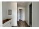 Hallway with tile flooring, leading to a walk-in closet and bathroom area with modern cabinets at 15769 W Beryl Ave, Waddell, AZ 85355