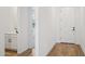 Inviting hallway with wood floors leading to a powder room at 15769 W Beryl Ave, Waddell, AZ 85355