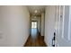 Inviting hallway with wood floors leading to a bright living area and sliding glass doors at 15769 W Beryl Ave, Waddell, AZ 85355