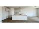 Bright, unfinished kitchen with an island and new cabinets, seamlessly connected to living area at 15769 W Beryl Ave, Waddell, AZ 85355