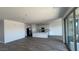 Spacious kitchen with white cabinetry flows into an open living area with modern tile flooring at 15769 W Beryl Ave, Waddell, AZ 85355