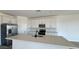 Bright kitchen with stainless steel appliances, island sink, and white cabinets at 15769 W Beryl Ave, Waddell, AZ 85355