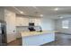 Modern kitchen with white cabinets, stainless steel appliances, and a large center island at 15769 W Beryl Ave, Waddell, AZ 85355