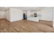 Bright open concept kitchen with stainless steel appliances and wood look floors with views to living area at 15769 W Beryl Ave, Waddell, AZ 85355