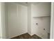 Laundry room featuring new flooring with washer and dryer hookups, and overhead shelf at 15769 W Beryl Ave, Waddell, AZ 85355