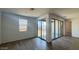 Living room area with natural light, and sliding glass doors that open to the backyard at 15769 W Beryl Ave, Waddell, AZ 85355