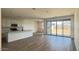 Open-concept living room featuring a kitchen, and sliding glass doors leading to the backyard at 15769 W Beryl Ave, Waddell, AZ 85355