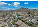 Aerial view of a neighborhood with mountain views and blue skies at 16018 N 17Th Way, Phoenix, AZ 85022