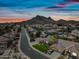 Scenic aerial view of a neighborhood with mountain views, mature trees, and blue skies at 16018 N 17Th Way, Phoenix, AZ 85022