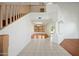 Bright foyer with high ceilings, wood floors, decorative columns, and a staircase leading to the upper level at 16018 N 17Th Way, Phoenix, AZ 85022