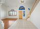 Bright open foyer featuring beautiful floors, a decorative window, and staircase access to the upper level at 16018 N 17Th Way, Phoenix, AZ 85022