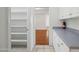 Walk-in pantry featuring multiple shelves and access to the kitchen and living area at 16018 N 17Th Way, Phoenix, AZ 85022