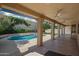 Covered patio view with ceiling fans overlooking a beautiful pool and manicured landscaping at 16018 N 17Th Way, Phoenix, AZ 85022